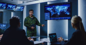 CSCI We Manage Risk When it Matters Most members reviewing map on a screen