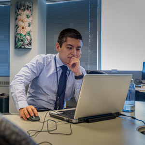 CSCI team member working at a laptop